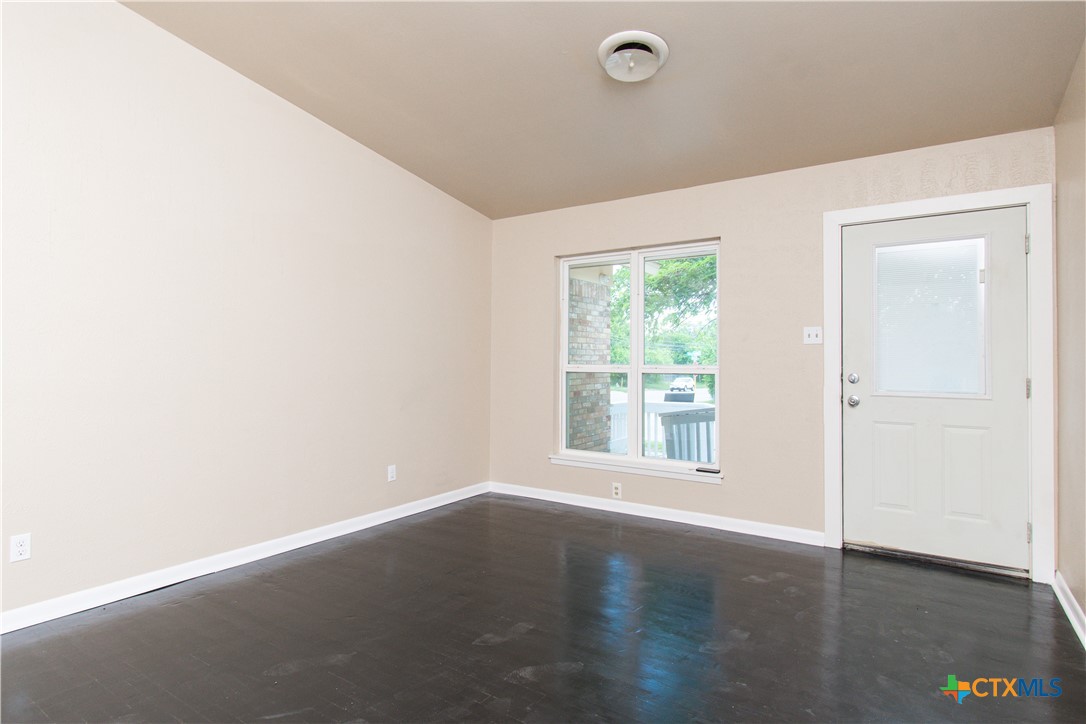1312 Stephen Street Killeen, TX 76549 - Photo 3 of 19 an empty room with wooden floor and windows