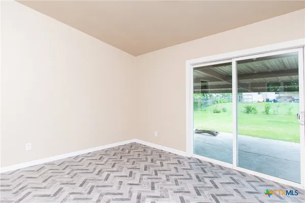 a view of empty room with floor to ceiling window