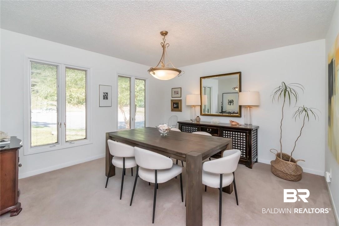 305 Fern Hill Court Mobile, AL 36608 - Photo 8 of 53 Carpeted dining space with a textured ceiling