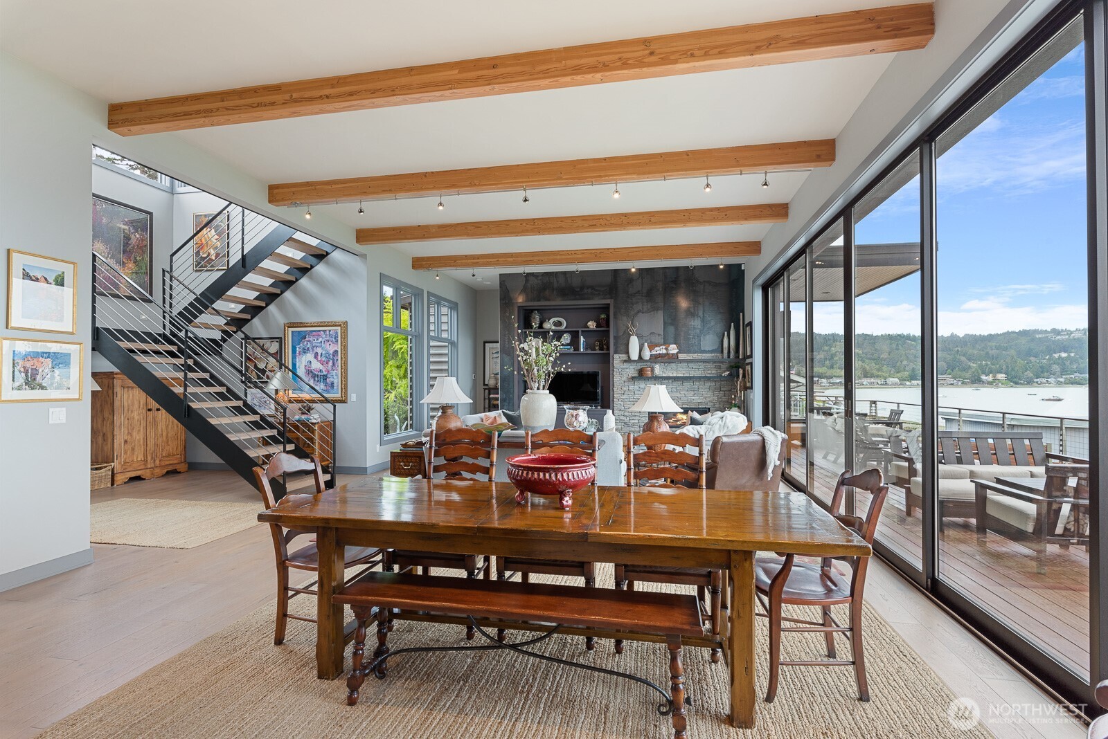 181 Utsalady Road Camano Island, WA 98282 - Photo 17 of 40 a dining room with furniture and a floor to ceiling window