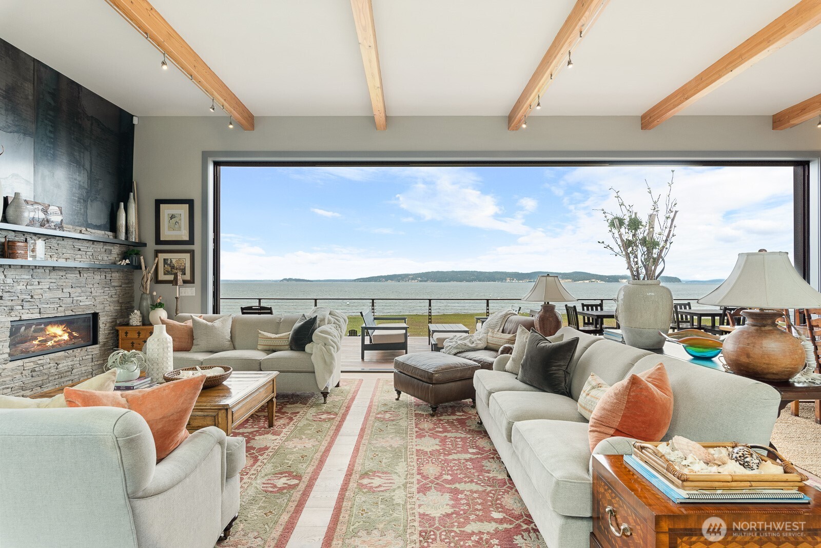 181 Utsalady Road Camano Island, WA 98282 - Photo 3 of 40 a living room with furniture a fireplace and a floor to ceiling window