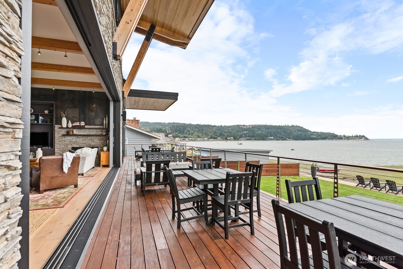 181 Utsalady Road Camano Island, WA 98282 - Photo 33 of 40 a view of a balcony with furniture and wooden floor