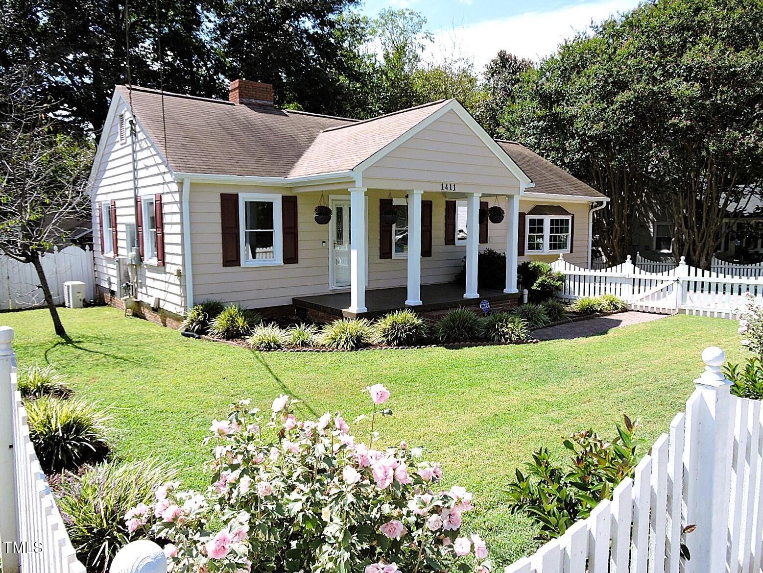 a front view of a house with a yard and porch
