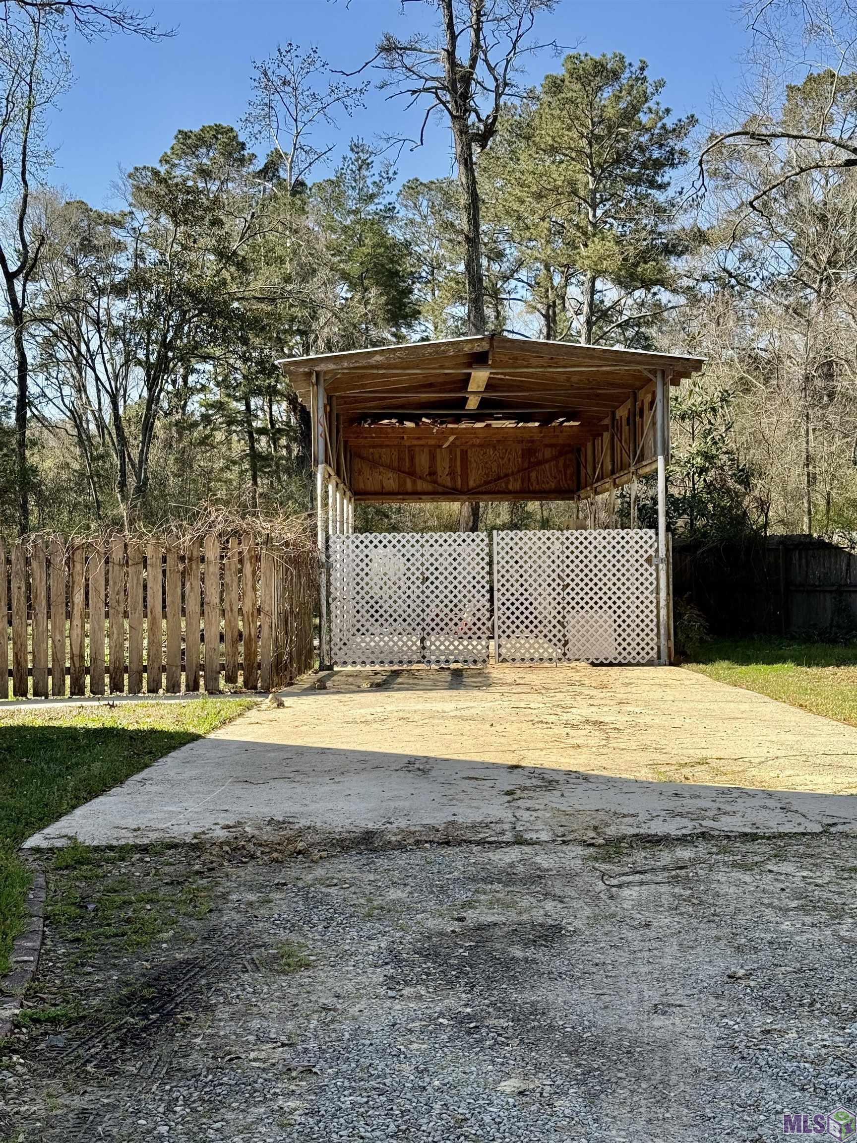 16706 Planchet Road Greenwell Springs, LA 70739 - Photo 14 of 14 PRIVATE PARKING PAD FOR DOWNSTAIRS APARTMENT AND COVERED STORAGE PORT FOR MAIN HOUSE