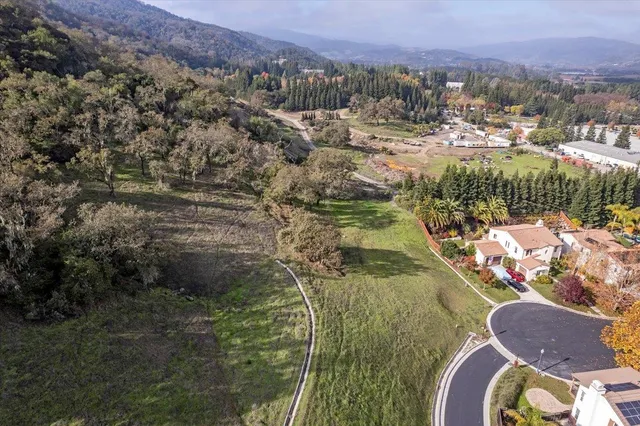 a view of a yard with wooden fence