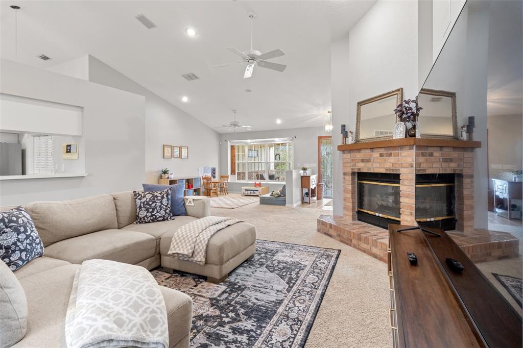 5301 Merrifield Court Spring Hill, FL 34608 - Photo 11 of 46 a living room with furniture and a fireplace