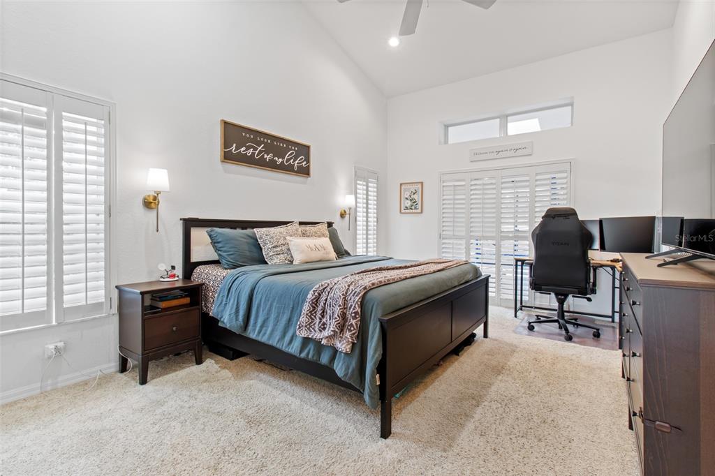 5301 Merrifield Court Spring Hill, FL 34608 - Photo 14 of 46 a bedroom with a bed and a chair
