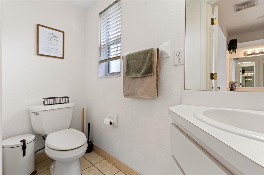 5301 Merrifield Court Spring Hill, FL 34608 - Photo 17 of 46 a bathroom with a toilet sink and mirror