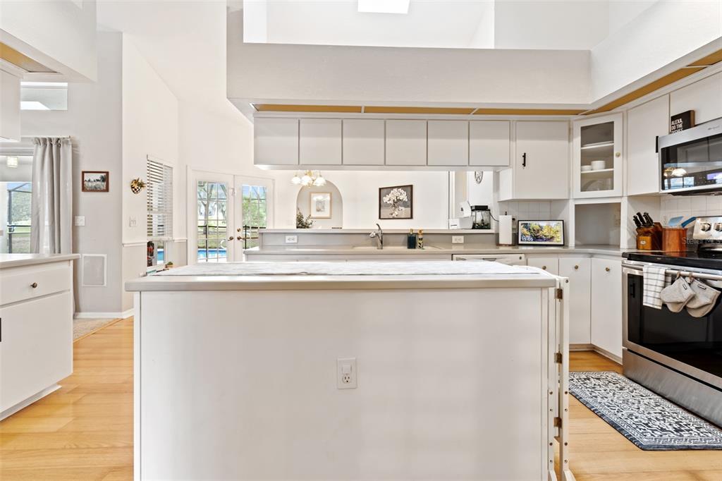 5301 Merrifield Court Spring Hill, FL 34608 - Photo 21 of 46 a kitchen with stainless steel appliances a refrigerator sink and cabinets
