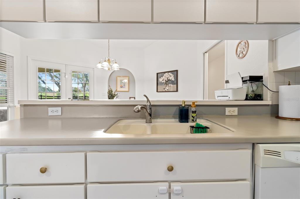5301 Merrifield Court Spring Hill, FL 34608 - Photo 23 of 46 a kitchen with a sink and a clock on the wall