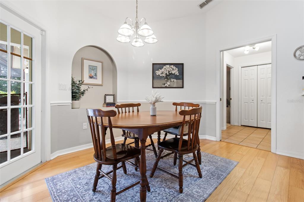 5301 Merrifield Court Spring Hill, FL 34608 - Photo 24 of 46 a view of a dining room with furniture window and wooden floor