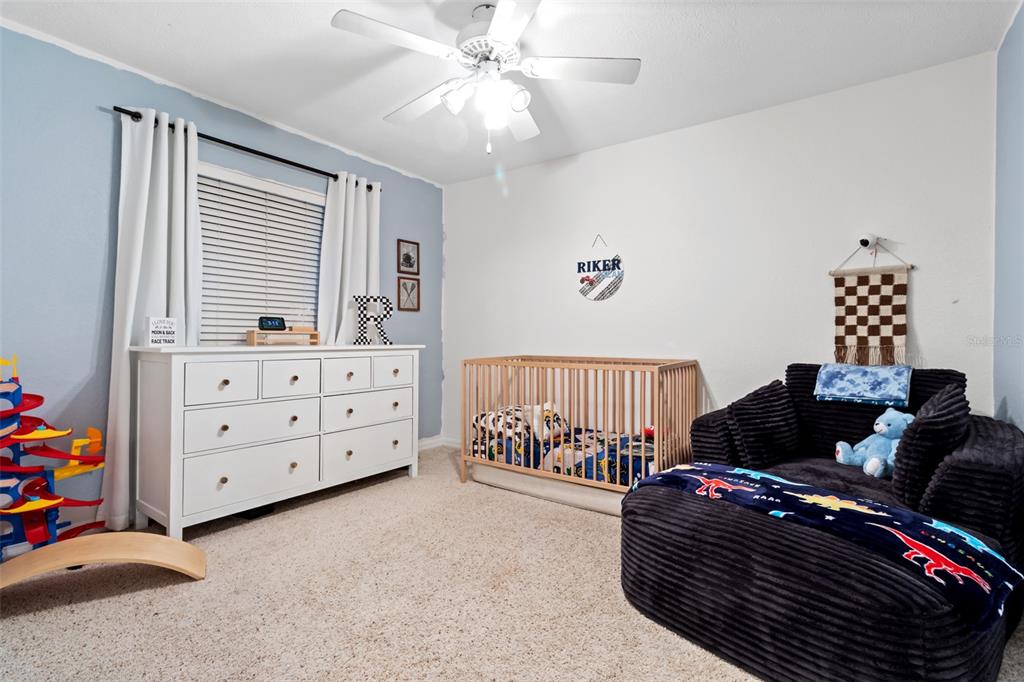 5301 Merrifield Court Spring Hill, FL 34608 - Photo 28 of 46 a bedroom with furniture and a window