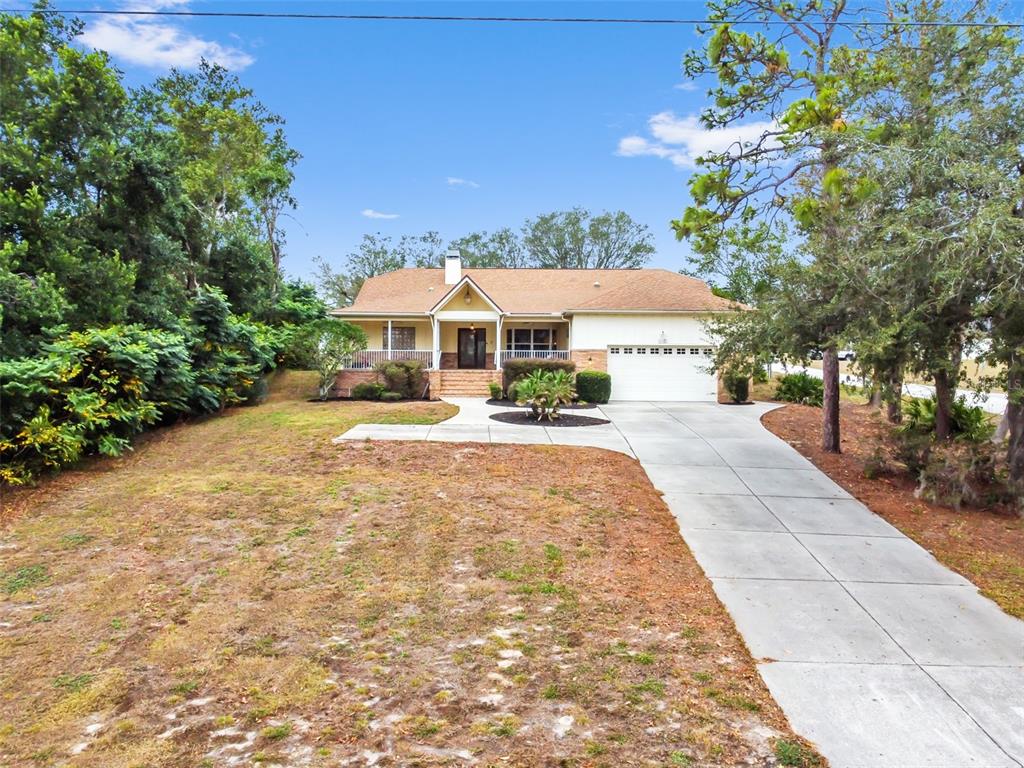 5301 Merrifield Court Spring Hill, FL 34608 - Photo 3 of 46 a front view of a house with a yard