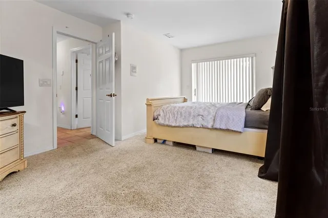 a bedroom with bed and a window