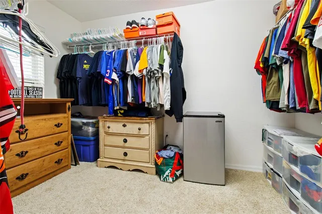 a children room with furniture and a large window