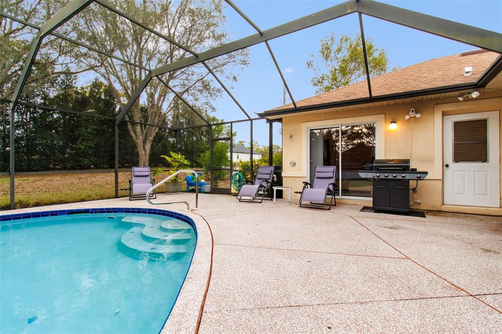 5301 Merrifield Court Spring Hill, FL 34608 - Photo 40 of 46 a view of a swimming pool with an outdoor seating