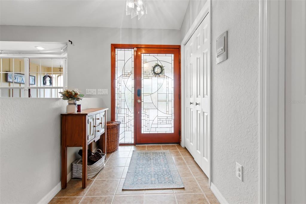 5301 Merrifield Court Spring Hill, FL 34608 - Photo 6 of 46 a view of a hallway with windows and chandelier