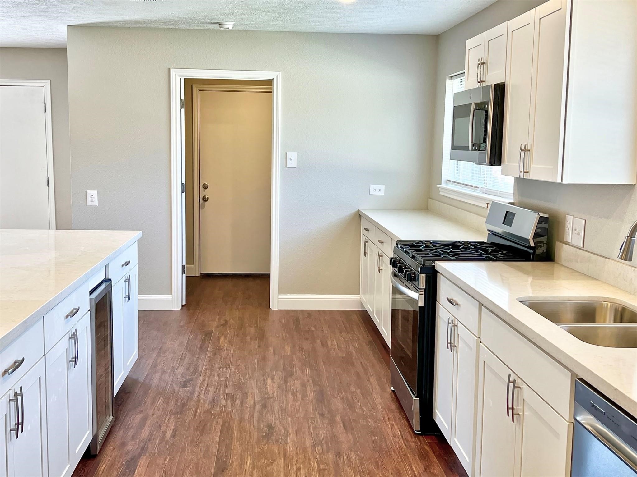 415 Sevenhampton Lane Houston, TX 77015 - Photo 2 of 28 Stainless steel appliances include the gas range, dishwasher and a mini beverage fridge