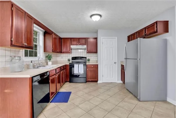 a kitchen with stainless steel appliances granite countertop a refrigerator sink and cabinets