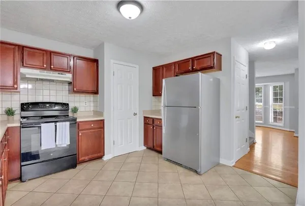 a kitchen with stainless steel appliances granite countertop a refrigerator and a stove top oven