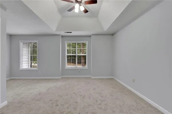 an empty room with a empty space and windows