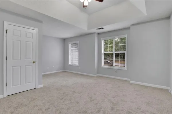 an empty room with windows and closet