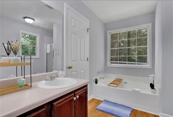 a view of a bathroom with a tub sink and mirror