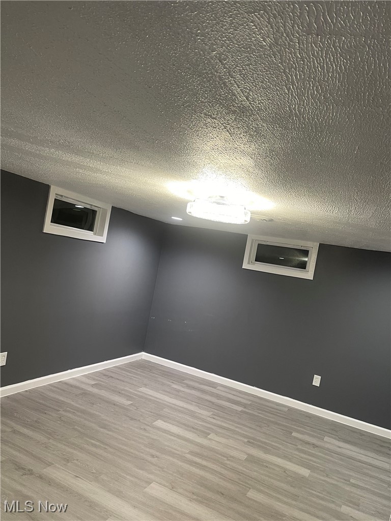 603 Liberty Road Youngstown, OH 44505 - Photo 25 of 42 Empty room with a textured ceiling and light wood-type flooring