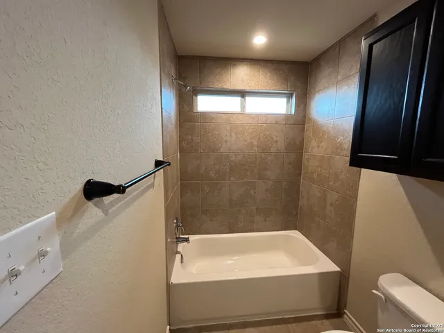 a bathroom with a tub and a shower