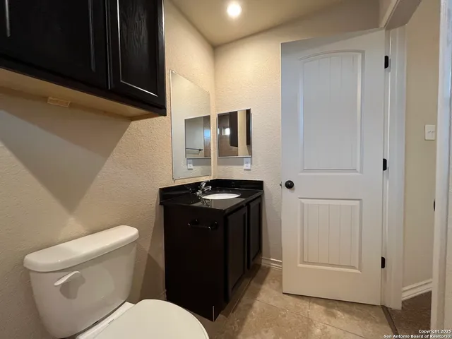 a bathroom with a toilet sink and mirror