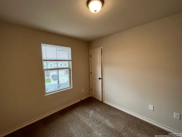 an empty room with windows and closet