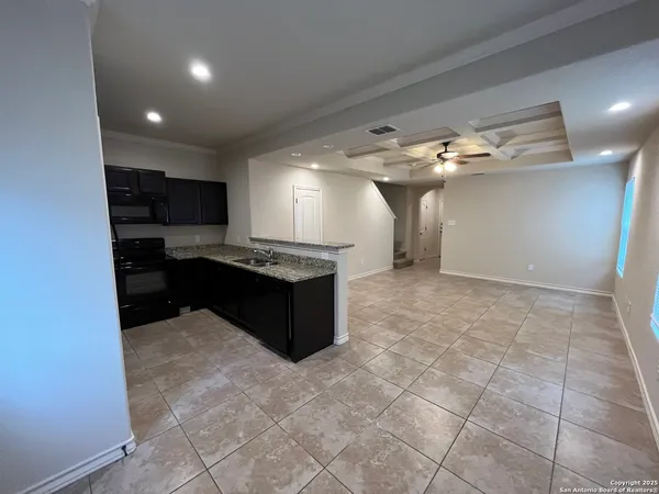 a kitchen with kitchen island a counter top space appliances and a cabinets