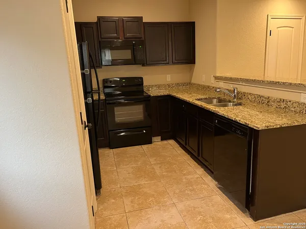 a kitchen with a sink and a refrigerator