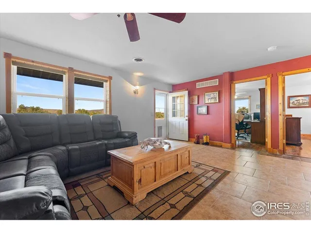 a living room with furniture and large windows