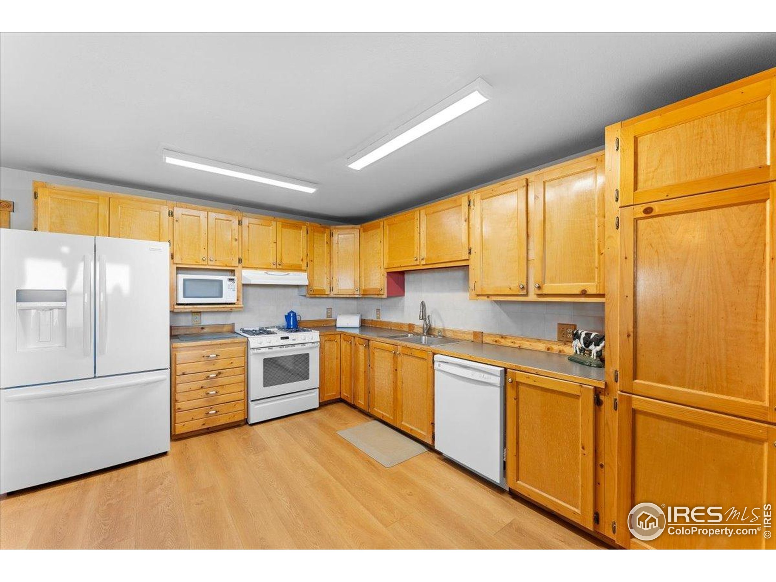 1721 West Co Road 68 Fort Collins, CO 80524 - Photo 20 of 50 a kitchen with stainless steel appliances granite countertop a refrigerator a sink dishwasher a stove and a large window