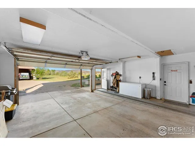 a view of a livingroom with furniture and a hallway