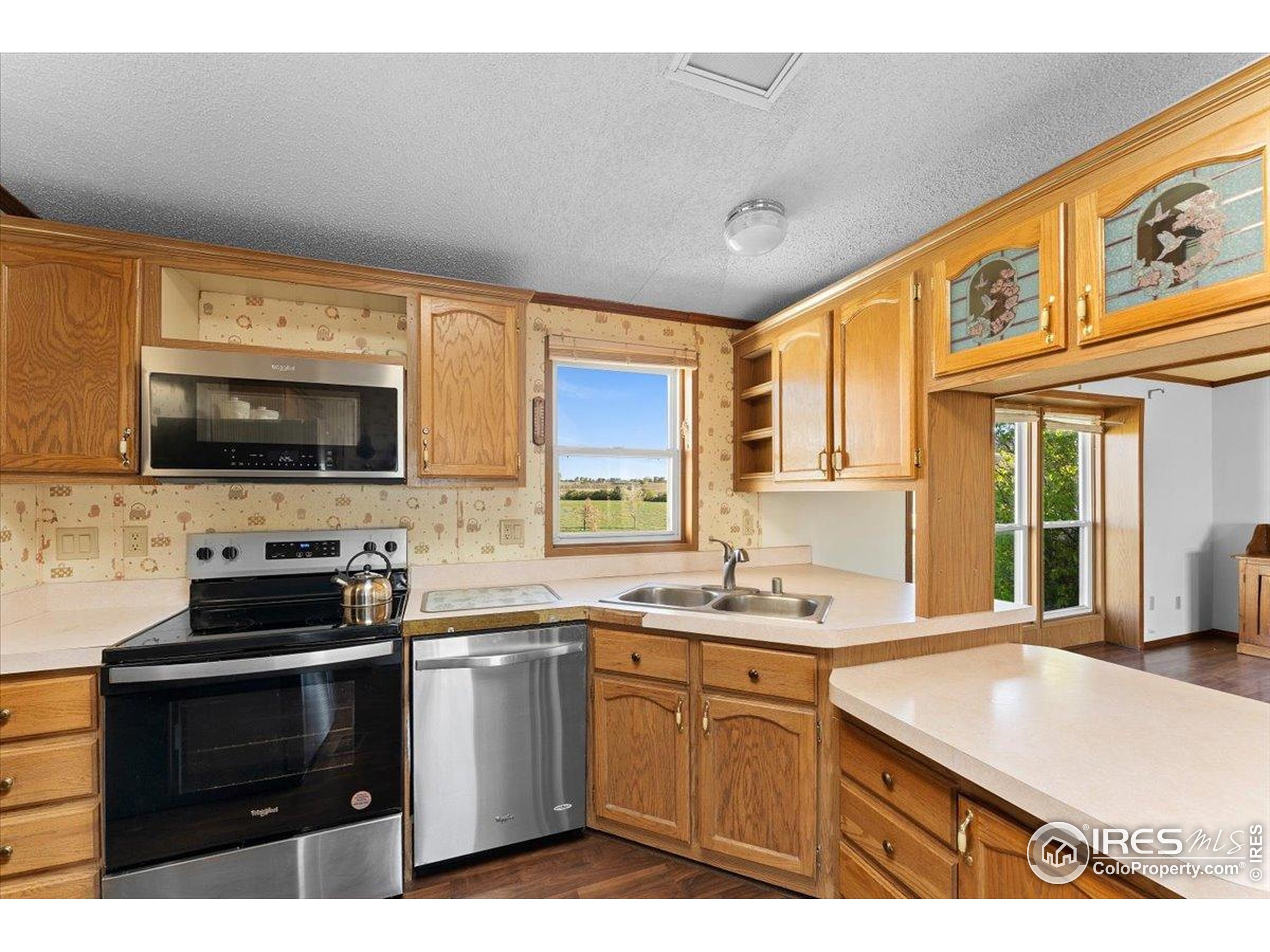 1721 West Co Road 68 Fort Collins, CO 80524 - Photo 36 of 50 a kitchen with stainless steel appliances a stove sink microwave and cabinets