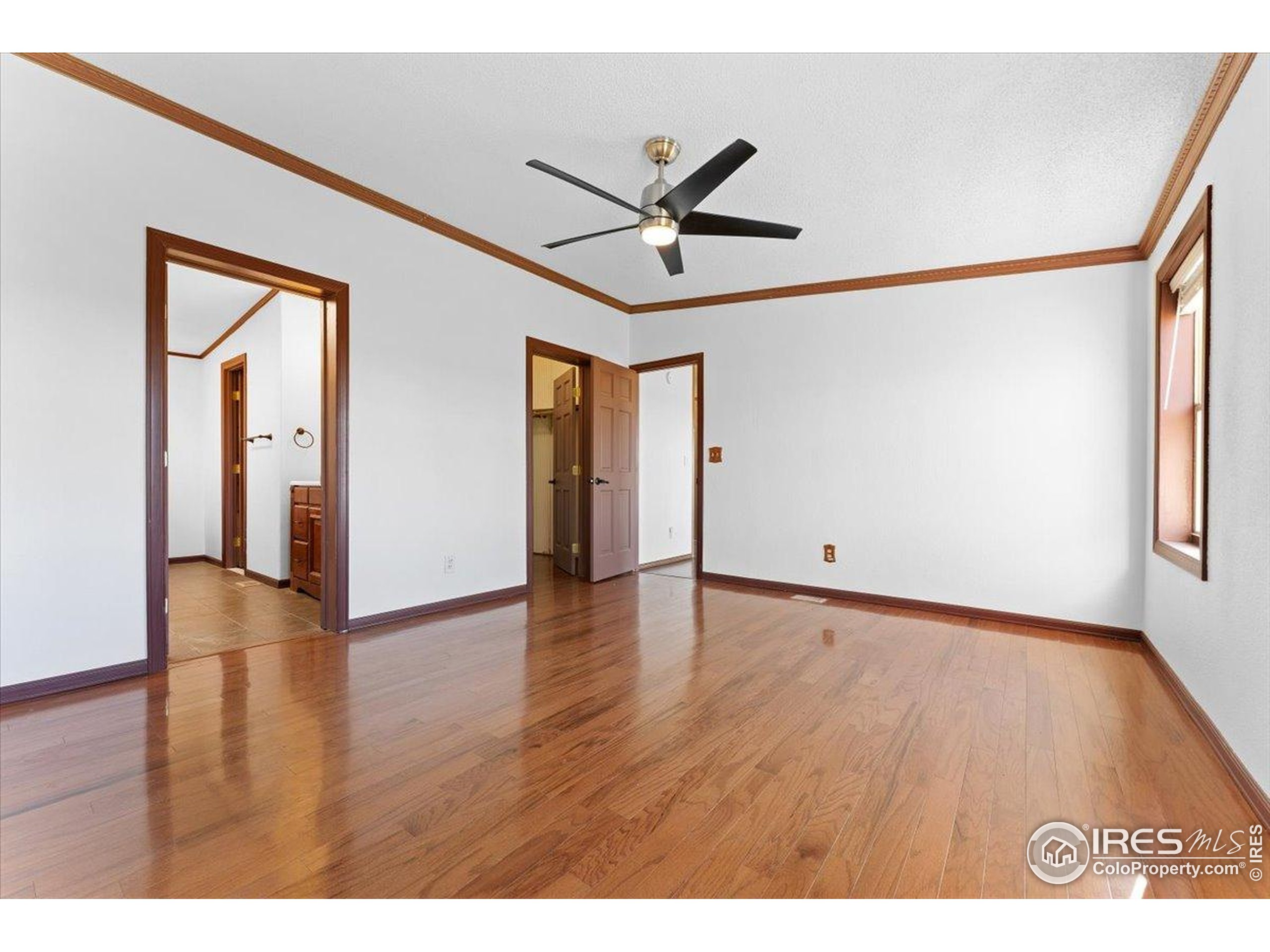1721 West Co Road 68 Fort Collins, CO 80524 - Photo 37 of 50 a view of an empty room with wooden floor and a window