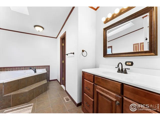 a bathroom with a sink a toilet a mirror and shower