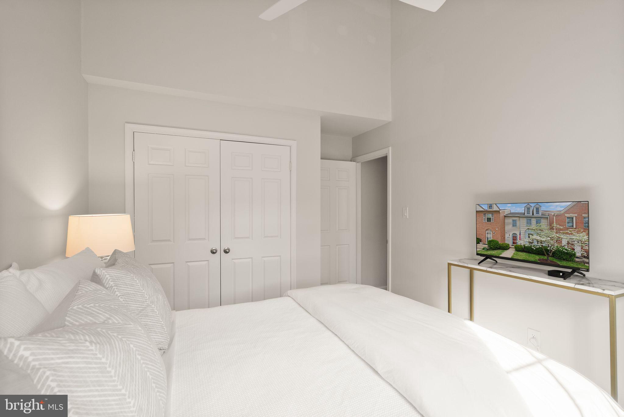 6369 English Ivy Way Springfield, VA 22152 - Photo 43 of 62 a bedroom with a bed and a flat screen tv