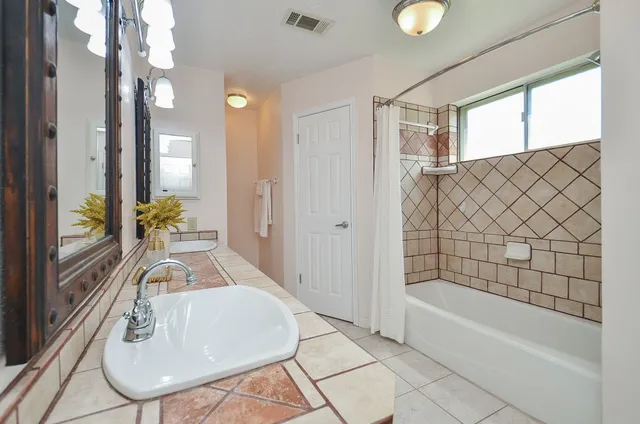 a bathroom with a sink a bathtub and a shower
