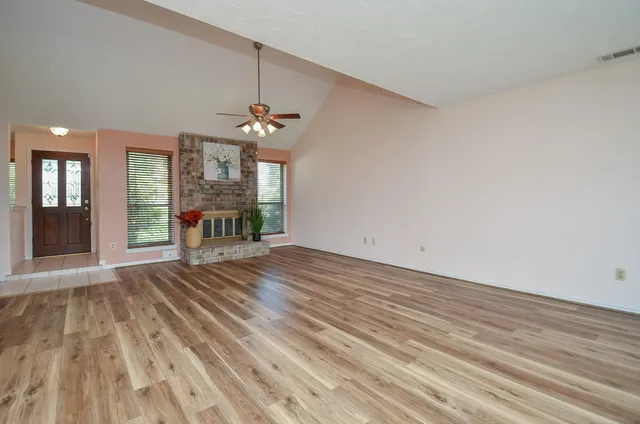 wooden floor in an empty room with a window