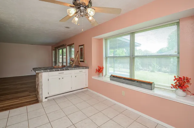 a room with a chandelier and view of living room