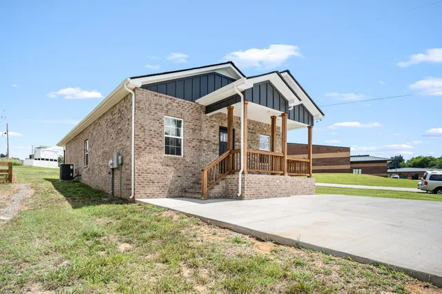 a view of a house with a yard and slide