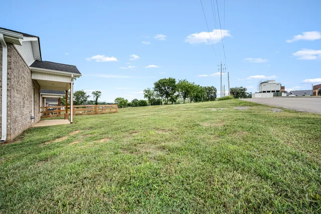 a view of a house with a backyard