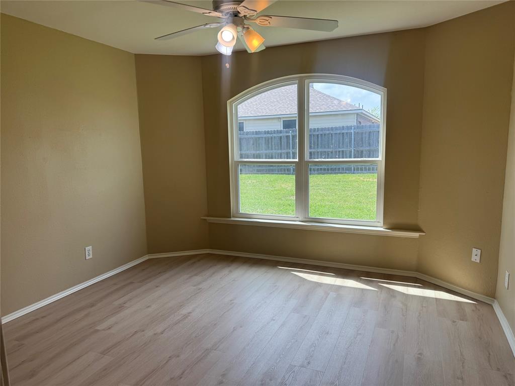 908 Cedar Ridge Lane Burleson, TX 76028 - Photo 8 of 24 an empty room with wooden floor and windows