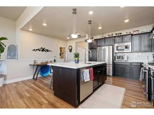 a kitchen with stainless steel appliances kitchen island a refrigerator and a stove