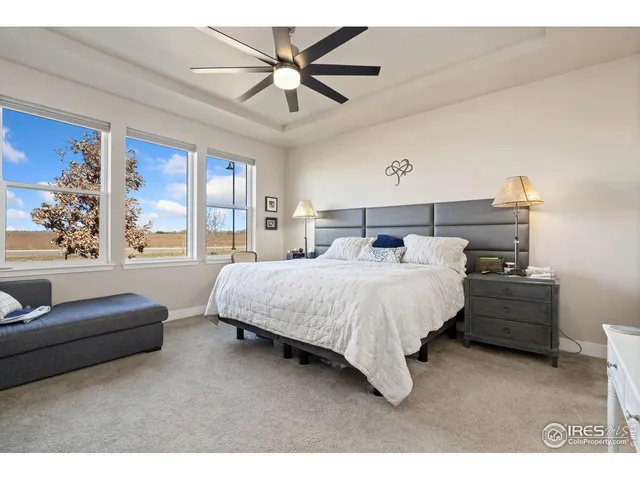 a bedroom with a large bed and a couch