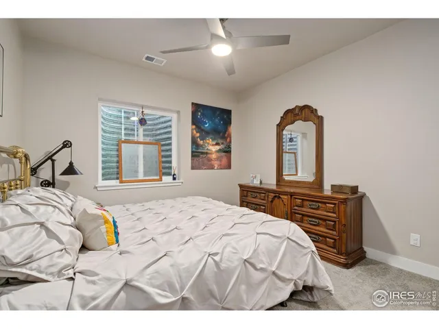 a bedroom with a bed next to a window with outer view
