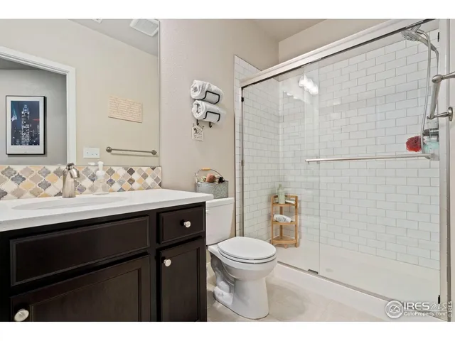 a bathroom with a sink vanity mirror and toilet